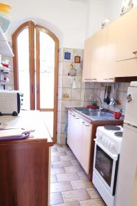 Una cocina con una estufa blanca y un fregadero. en Le Pleiadi - Casa Casoni, en Marcelli
