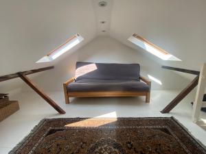a couch in a room with two lights and a rug at Three Bedroom House in Central Richmond in Richmond upon Thames