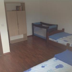 a small room with two beds and a cabinet at Guest House "Paradise" in Tivat