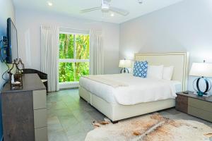 a white bedroom with a bed and a window at Elan at Ballena Beach in Uvita +144 photos