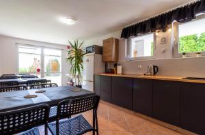a kitchen and dining room with a table and chairs at Willa Niezapominajka Mielno in Mielno