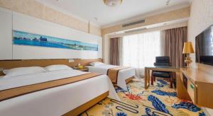Postel nebo postele na pokoji v ubytování Vienna Hotel Guangdong Zhuhai Mingzhu Station Guozheng