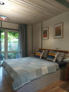 a bedroom with a large bed and a window at Guest House Serena in Chornomorsk