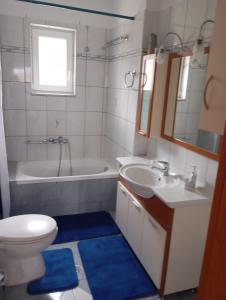 a bathroom with a toilet and a sink and a tub at DREAM Home Ioannina in Ioannina