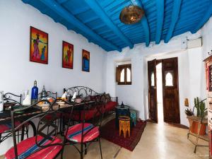 カサジャ・デ・ラ・シエラにあるLa Andalusiの青い天井の客室で、テーブルと椅子が備わります。