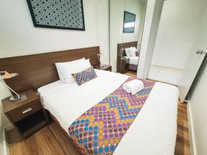 Postel nebo postele na pokoji v ubytování Exodus Dandenong Apartment Hotel