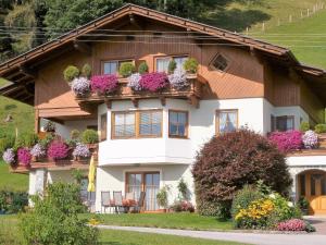 a house with flowers on the balconies at Haus Silvia in Werfenweng