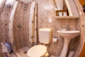 a small bathroom with a toilet and a sink at Azur Apartment in Budva +52 photos