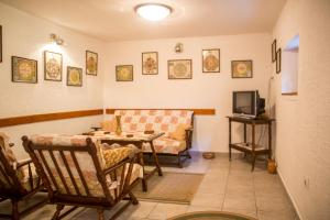 a living room with a couch and a tv at Azur Apartment in Budva