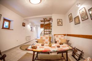 a living room with a table and some chairs at Azur Apartment in Budva