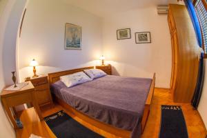 a bedroom with a bed with a purple bedspread at Azur Apartment in Budva