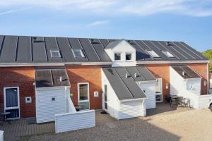 a row of houses with solar panels on their roofs at Summer House On Beautiful Rømø! in Sønderby
