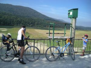 a man and a boy standing next to two bikes at Turistična Kmetija Logar in Grahovo