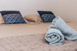 a bed with a towel on top of it at Maison de village climatisée Entre Béziers et Narbonne jusqu'à 5 pers in Coursan +53 photos
