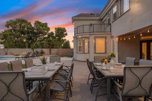 a patio with tables and chairs and a pool at The Country House home in Hurricane