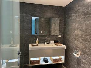 a bathroom with a sink and a mirror at GOGO Hotel 市政館 in Taichung +33 photos