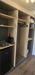 a kitchen with wooden shelves and a counter top at Vila Luna in Vama Veche +24 photos