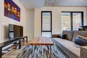 a living room with a couch and a table at The Downtown Oasis in Montréal