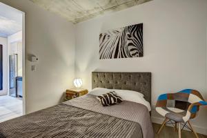 a bedroom with a bed and a zebra picture on the wall at The Downtown Oasis in Montréal
