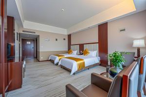 Postel nebo postele na pokoji v ubytování Zhangjiajie Chensheng International Hotel