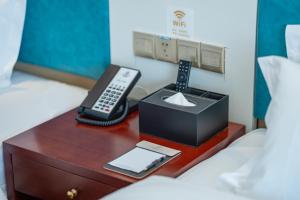 Postel nebo postele na pokoji v ubytování Zhangjiajie Chensheng International Hotel