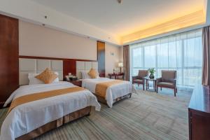 Postel nebo postele na pokoji v ubytování Zhangjiajie Chensheng International Hotel