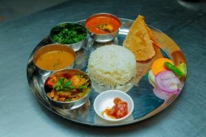 a plate of food with rice and different types of food at Hotel Kedarnath in Kathmandu +8 photos