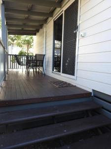 a screened in porch with a table and chairs on it at Dalby Tourist Park in Dalby +72 photos