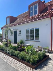 a white house with a red roof at Villa Lysholmen in Särö +10 photos