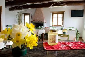 a table with flowers and a jar on top of it at Agriturismo Prato Fiorito in Bagni di Lucca
