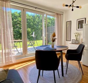 a dining room with a table and chairs and a large window at Stilvolles Appartement in Jena
