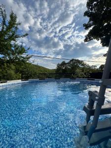 a large pool of blue water with a cloudy sky at Kuća za odmor Krasnica in Novi Vinodolski