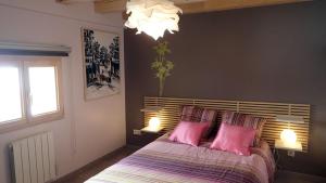 a bedroom with a large bed with pink pillows at La Grange in Lautenbachzell +14 photos