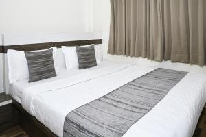 Ένα ή περισσότερα κρεβάτια σε δωμάτιο στο Hotel JP Grand