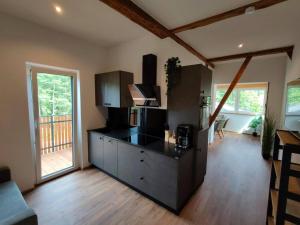 a kitchen with a black counter top in a room at Burgbichl Apartments in Rothenthurn
