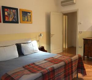 a bedroom with a bed with a blanket on it at Elegante in centro in Imola