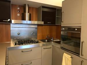 a kitchen with a stove and a sink at Elegante in centro in Imola +6 photos