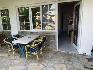 a table and chairs sitting on a patio at LAINAS apartments in Nea Skioni +18 photos