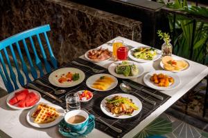 a table with plates of food and drinks on it at Sea Lavie Boutique Resort & Spa in Hoi An +69 photos