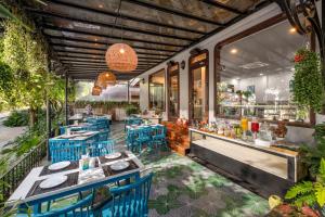a restaurant with blue tables and blue chairs at Sea Lavie Boutique Resort & Spa in Hoi An