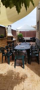 a group of tables and chairs on a patio at La Casa del Cerezo in Nambroca