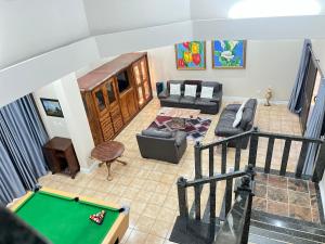 an overhead view of a living room with a pool table at Marionguesthouse in Ballito