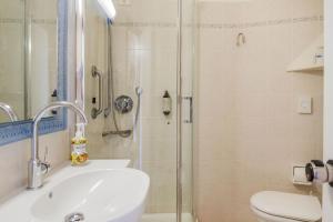 a bathroom with a shower and a sink and a toilet at Piccolo Hotel in Castiglione della Pescaia +28 photos