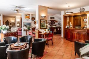 a living room with a table and chairs at Piccolo Hotel in Castiglione della Pescaia
