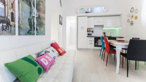 a living room with a couch and a table with chairs at Rental in Rome Palermo apartment in Rome