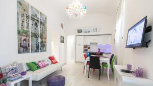 a living room with a couch and a dining room at Rental in Rome Palermo apartment in Rome