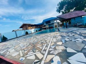 a building with a tile floor in front of a building at MSS Hotel in Trincomalee