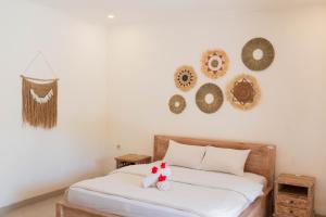 Postel nebo postele na pokoji v ubytování Bramasa Ubud Guest House