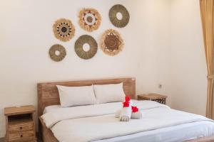 Postel nebo postele na pokoji v ubytování Bramasa Ubud Guest House