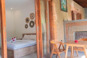 Postel nebo postele na pokoji v ubytování Bramasa Ubud Guest House